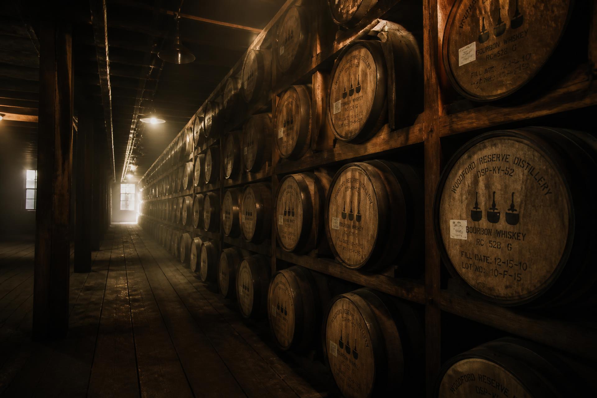 Rows of oak barrels aging in a warehouse